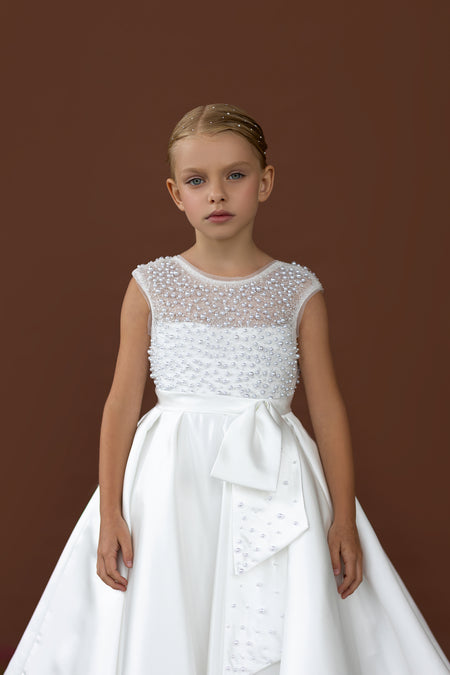 Elegant white flower girl dress Australia with pearl beaded bodice and satin bow, perfect flower girl gown for weddings and parties.