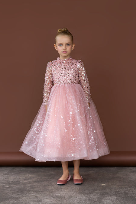 Girl in pink sequin flower girl dress with long sleeves and tulle skirt, elegant flower girl gown Australia.