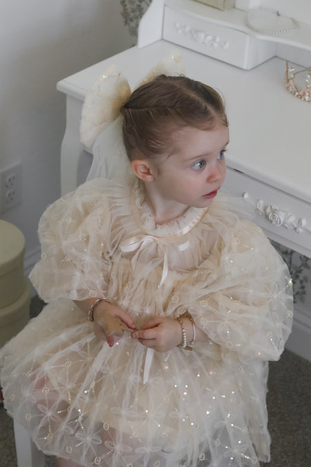 Charming Champagne flower girl dress Australia with puff sleeves and bow detail, luxury flower girl gown for weddings.