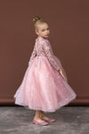Side view of pink beaded gown with flared tulle hem
