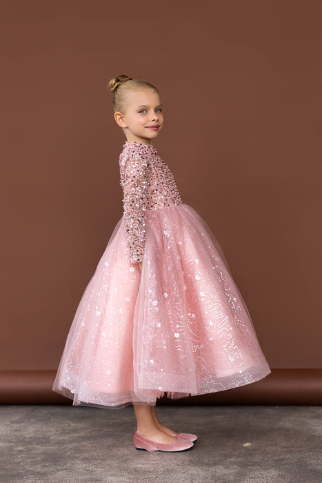 Side pose of girl wearing glittery pink dress with sequin details