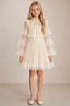 Girl wearing an ivory white long sleeve tulle party dress with tiered ruffles