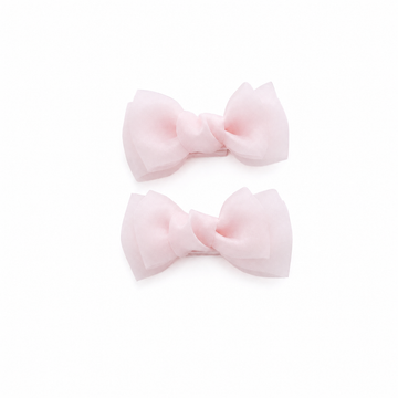 Pink bow hair clips for girls on a white background