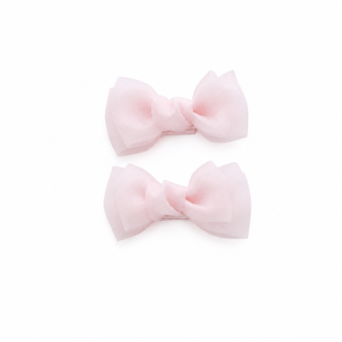 Pink bow hair clips for girls on a white background