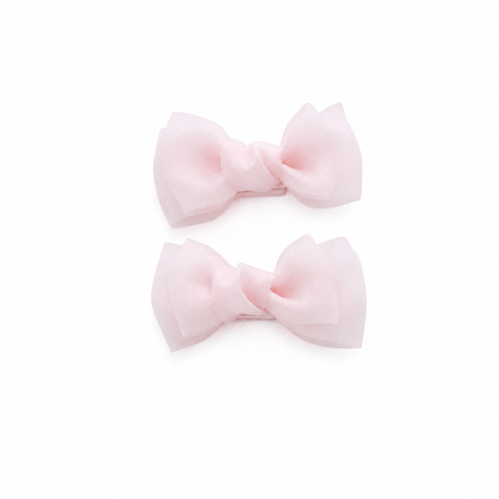 Pink bow hair clips for girls on a white background