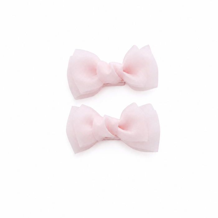 Pink bow hair clips for girls on a white background