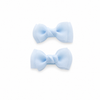 Light blue bow hair clips for girls on a white background