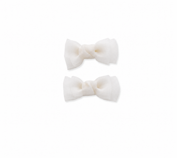 White bow hair clips for girls on a white background