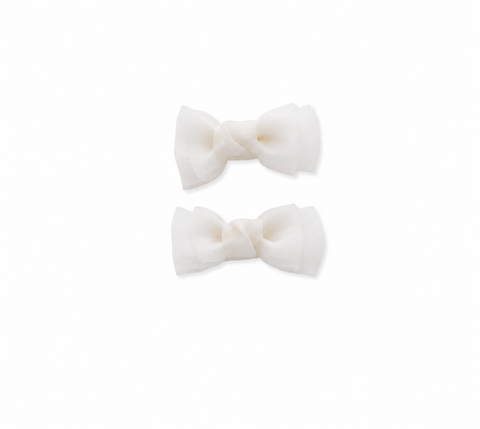 White bow hair clips for girls on a white background