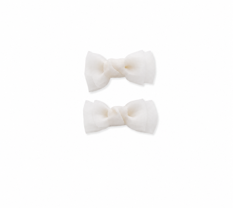 White bow hair clips for girls on a white background