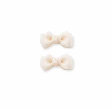 Cream bow hair clips for girls on a white background