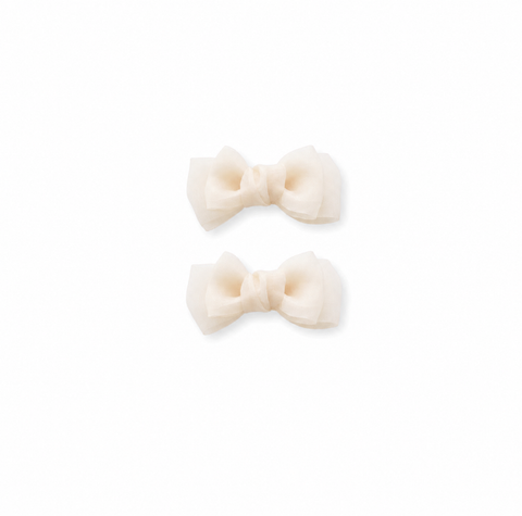 Cream bow hair clips for girls on a white background