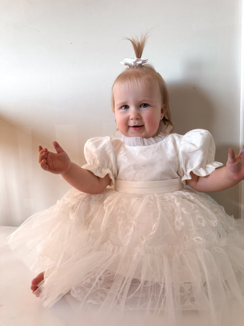 Baby girl in white puff sleeve flower girl outfit, adorable flower girl dress Australia.