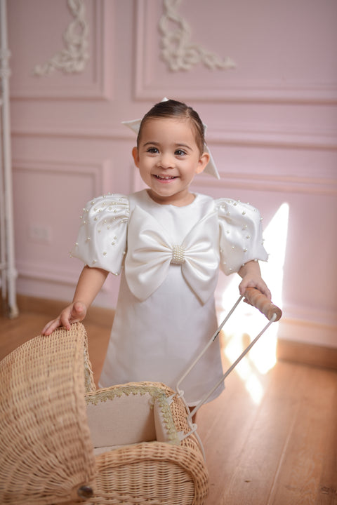 Girl in white puff sleeve flower girl dress with oversized bow, elegant flower girl gown Australia.