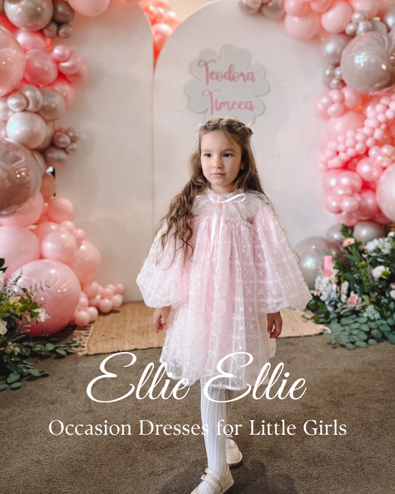 girl in pink beaded dress with long sleeves at birthday photoshoot