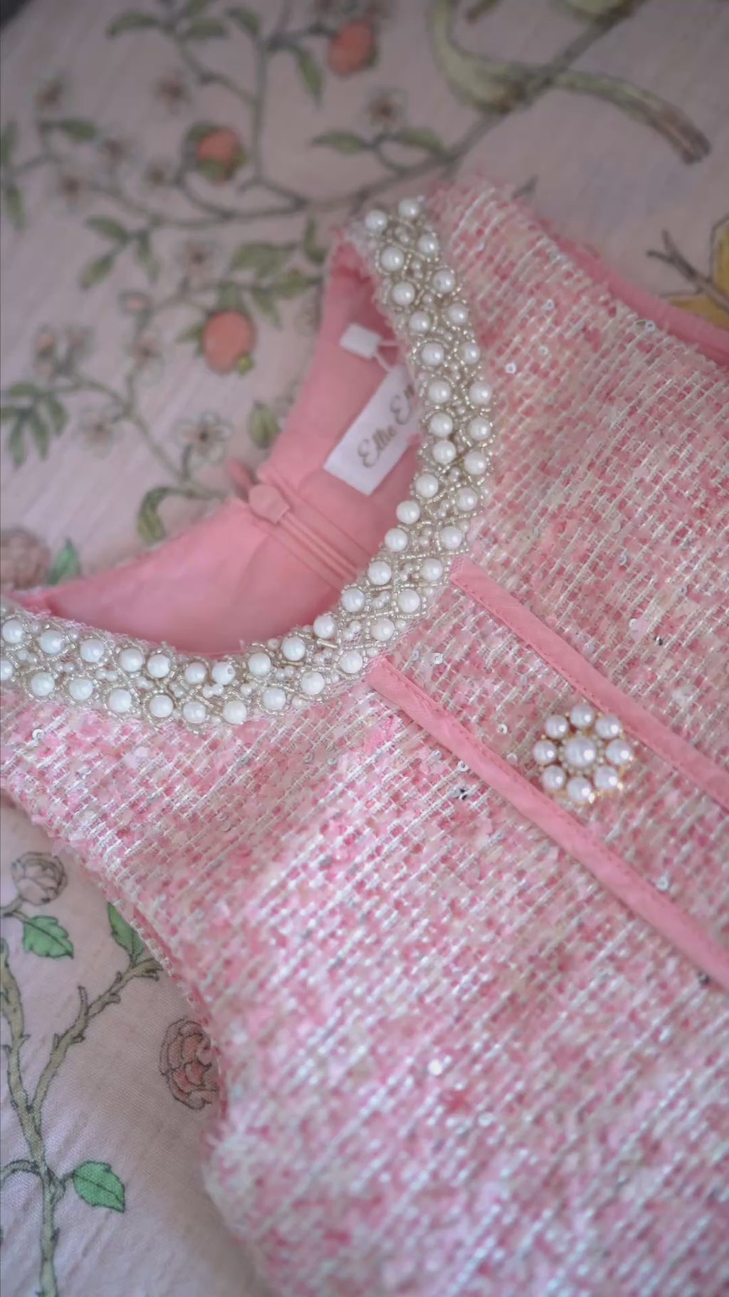 pearl and rhinestone embellishment on neckline of pink tweed girls dress