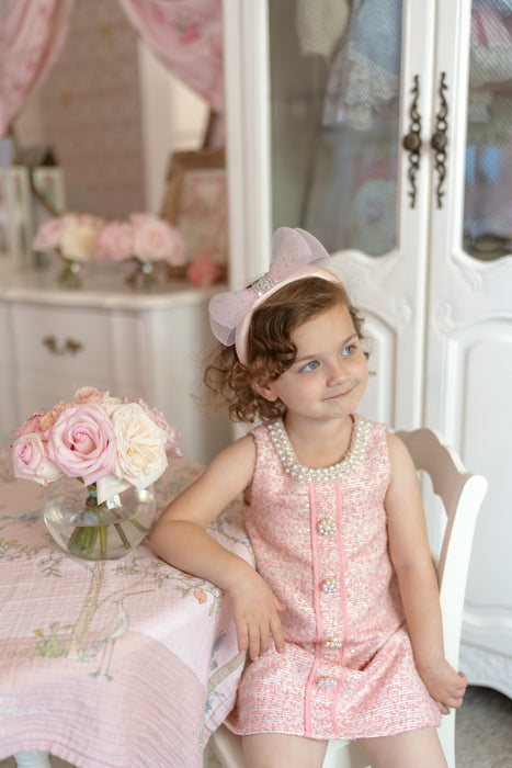 birthday girl in elegant pink tweed dress with sparkle details