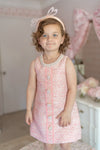 girl wearing pink tweed sleeveless dress with pearl trim for birthday party