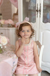 child in pink tweed party dress styled for elegant birthday celebration